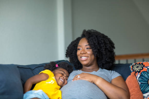 Happy Looking Pregnant Black Woman And Child